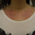 Two chest piercings